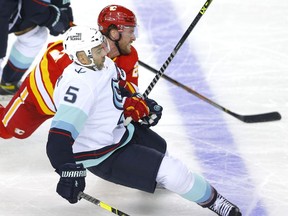 The Calgary Flames’ Blake Coleman battles the Seattle Kraken’s Mark Giordano in pre-season action at the Scotiabank Saddledome in Calgary on Wednesday, Sept. 29, 2021.
