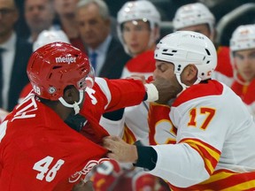 Red Wings winger Givani Smith trades blows with Calgary Flames counterpart Milan Lucic last night at Little Caesars Arena in Detroit.