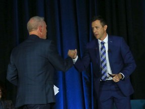 Mayor candidate Brad Field fist pumps Jeff Davison at the Calgary Chamber mayoral debate on October 6, 2021.
