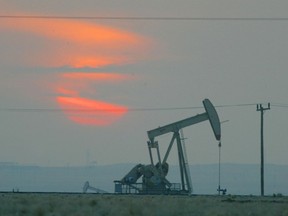 The sun sets behind a oil derek near the Saudi Arabian border.
