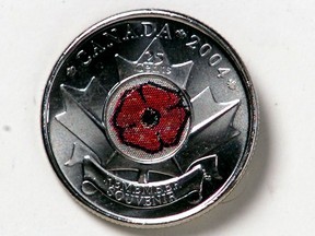 On this day in history, the Royal Canadian Mint unveiled the world's first coloured circulation coin -- a quarter featuring a red poppy embedded in the centre of a Maple Leaf, honouring Canadian veterans.  Postmedia Archives. -