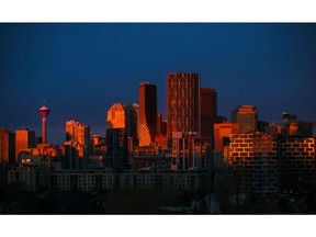 The sunrise reflects off the downtown Calgary skyline, with Bucci Developments' two signature buildings of Dominion on the right.
