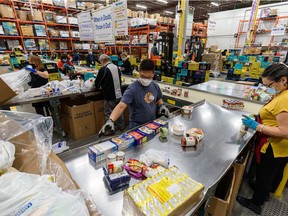 Volunteers sort the donated foods at Calgary Food Bank's warehouse. Azin Ghaffari/Postmedia