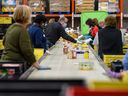 Volunteers sort donated foods at Calgary Food Bank’s warehouse on Wednesday, November 17, 2021.