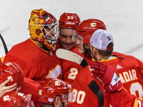The Calgary Flames celebrate a seven-round shootout against the Pittsburgh Penguins at the Scotiabank Saddledome in Calgary on Monday, Nov. 29, 2021.