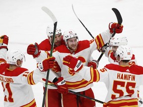 Flames sniper Andrew Mangiapane celebrates a goal with Mikael Backlund, Milan Lucic and Noah Hanifin during the second period of Saturday night's  tilt with the New York Islanders at UBS Arena in Elmont, New York.