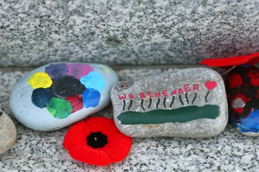 Painted rocks decorate a stone monument during Remembrance Day ceremonies at the Field of Crosses on Memorial Drive in northwest Calgary on Thursday, November 11, 2021. Jim Wells/Postmedia