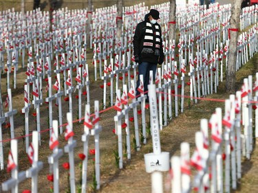 A visitor walks through the Field of Crosses during Remembrance Day ceremonies on Memorial Drive in northwest Calgary on Thursday, November 11, 2021. Jim Wells/Postmedia