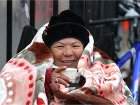 Please join the Calgary Herald/Calgary Sun Christmas Fund in supporting local charities that are helping Calgarians in need. Here, Lorraine Matheson sips a coffee and huddles in a blanket outside the Drop in Centre on Tuesday, November 23, 2021.