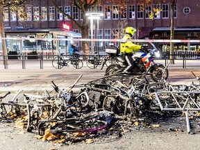 This photograph taken on November 20, 2021 shows burned bikes after a protest against the partial lockdown and against the 2G government policy in Rotterdam.