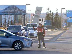 Calgary police block vehicle traffic back into the airport at Barlow Trail as anti-vax protestors planned to rally at the Calgary International Airport in Calgary on Sunday, November 7, 2021.