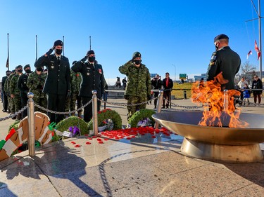 Canadian soldiers salute after placing their poppies at the eternal flame at the Military Museums following Remembrance Day ceremonies on Thursday, November 11, 2021. 

Gavin Young/Postmedia