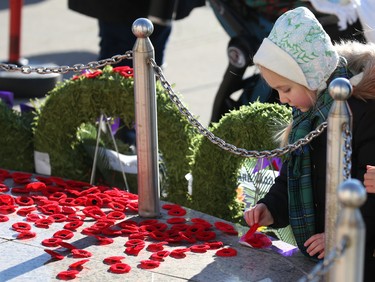 Children place their poppies at the eternal flame at the Military Museums following Remembrance Day ceremonies on Thursday, November 11, 2021. 

Gavin Young/Postmedia