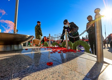 Canadian soldiers place their poppies at the eternal flame at the Military Museums following Remembrance Day ceremonies on Thursday, November 11, 2021. 

Gavin Young/Postmedia