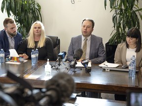 From left, Plaintiffs Cody Bonkowsky, Kelly Schneider, lawyer Jonathan Denis and plaintiff Eryn MacKenzie speak with media about their class-action lawsuit against the Calgary Board of Education and the estate of Michael Gregory, who was a teacher at John Ware Junior High School in Calgary. The claim alleges that, from approximately 1989 to 2006, Gregory sexually assaulted and interfered with approximately 200 teenage girls aged 14 to 16. The press conference took place on Monday, November 29, 2021.