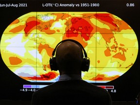 A delegate looks at a screen during the UN Climate Change Conference (COP26) in Glasgow, Scotland, Britain, November 8, 2021. REUTERS/Yves Herman