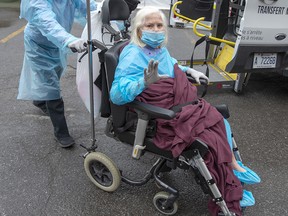 A resident waves as she is brought into the Vigi Mount Royal seniors residence on May 1, 2020, in Montreal.