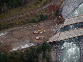 Crews work to repair washed-out bridges on the Coquihalla Highway north of Hope, B.C., on Monday, Nov. 22, 2021.