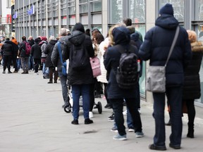 People queue up outside a vaccination centre in a shopping mall, amid the COVID-19 pandemic, in Berlin, Germany, November 20, 2021.