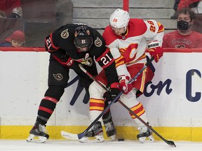 Ottawa Senators forward Nick Paul battles with Calgary Flames Elias Lindholm in the first period at the Canadian Tire Centre on Sunday, Nov. 14, 2021.