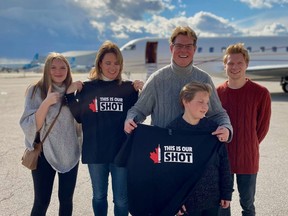 Julianne Powell, left, Melanie Powell, Jeremy Powell, Austin Powell and Zacahary Pennett stand in front of the private jet on which they enjoyed a free trip around southern Ontario on Friday, part of their COVID-19 vaccine prize from the This is Our Shot campaign.