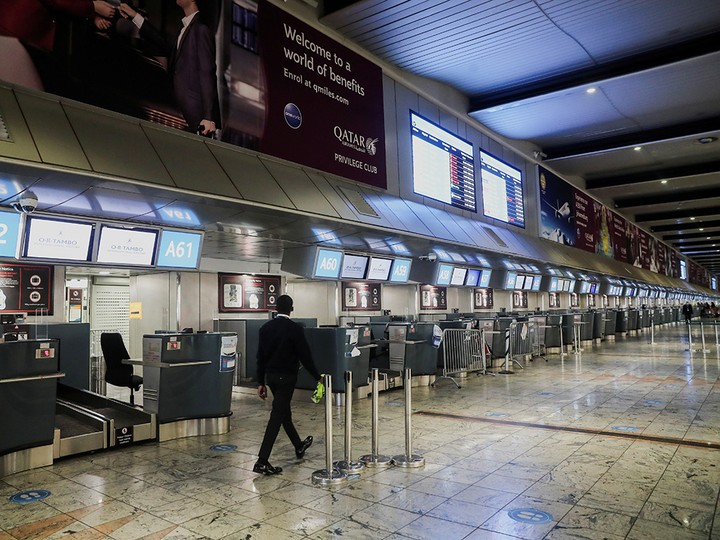  International check-in counters stand empty at O.R. Tambo International Airport in Johannesburg, South Africa, Nov. 28, 2021.