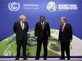 Britain's Prime Minister Boris Johnson (L) and United Nations (UN) Secretary General Antonio Guterres greet Angola's President Joao Loureco as they arrive to attend the COP26 UN Climate Change Conference in Glasgow, Scotland on November 1, 2021. - COP26, running from October 31 to November 12 in Glasgow will be the biggest climate conference since the 2015 Paris summit and is seen as crucial in setting worldwide emission targets to slow global warming, as well as firming up other key commitments. (Photo by Christopher Furlong / POOL / AFP)