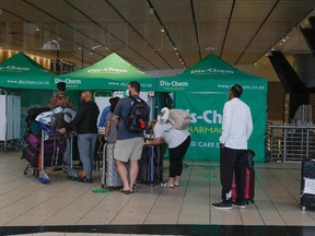 Travellers queue at an area for polymerase chain reaction (PCR) Covid-19 tests at OR Tambo International Airport in Johannesburg on Nov. 27, 2021.