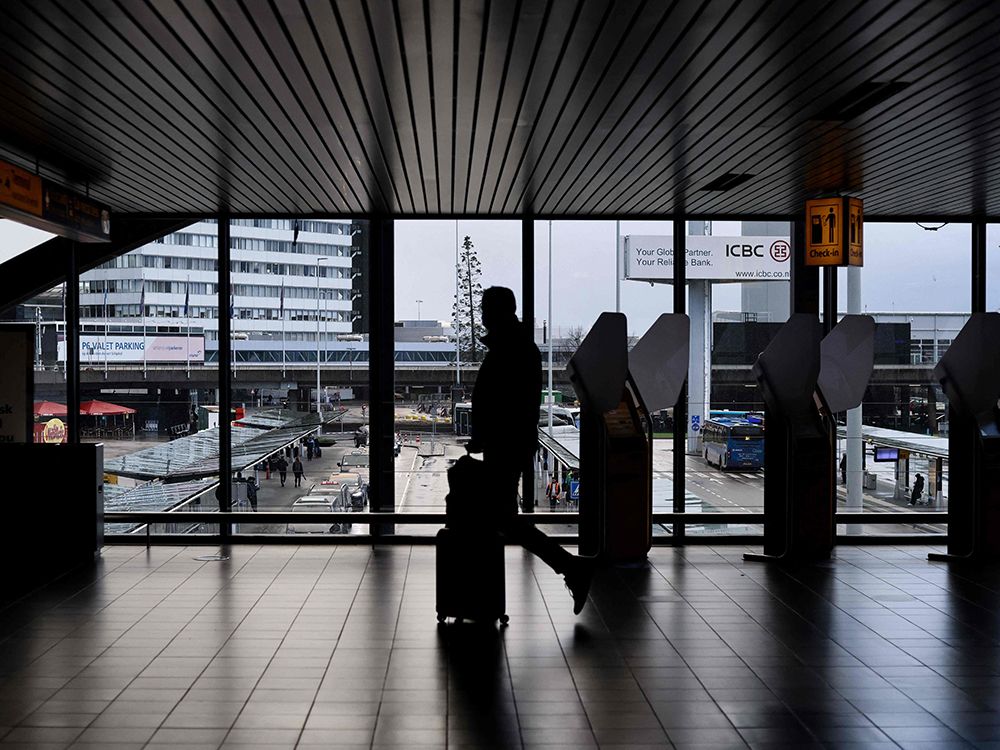  A passenger walks through the Schiphol airport in Amsterdam on Monday. Dutch health authorities said as of Nov. 29, the Omicron variant has been detected in 14 passengers arriving from South Africa.