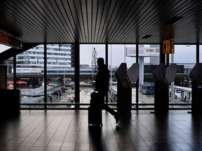 A passenger walks through the Schiphol airport in Amsterdam on Monday, Nov. 29, 2021. Dutch health authorities said as of Nov. 29, the Omicron variant has been detected in 14 passengers arriving from South Africa.