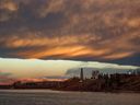 Sunrise with an interesting cloud-like arc created a dramatic scene over the Glenmore Reservoir and the oil rig at Heritage Park in Calgary on Wednesday, November 3, 2021. 