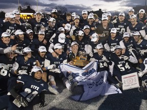 St. Francis Xavier University X-Men's captain Ben Von Muehldorfer holds the Jewett Trophy after defeating the Bishop's University Gaiters 25-17 to win the Atlantic University Sports Loney Bowl in Antigonish, N.S., on Saturday, Nov. 20.