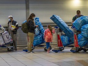 People line up to get on an overseas flight at OR Tambo's airport in Johannesburg, South Africa, on Friday, Nov. 26, 2021.