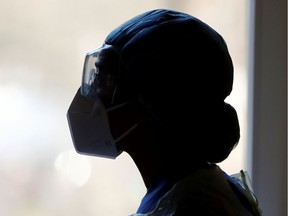A nurse looks out of a window in a treatment room as she treats a patient suffering from the coronavirus disease. Pastor John Val Sloten writes, "ICU nurses . . . walk with people who are walking through the valley of the shadow of death. As part of an ICU team, they are God’s caring provision at a person’s weakest time." 
 REUTERS/Fabrizio Bensch