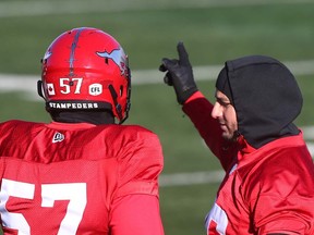 Long-snapper Randy Chevrier chats with place-kicker Rene Paredes during practice at McMahon Stadium on Wednesday.