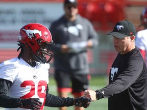 Calgary Stampeders DB Jamar Wall fist-bumps a member of the coaching staff during practice at McMahon Stadium earlier this season. On Tuesday, Wall was named recipient of the Stamps' Presidents' Ring.