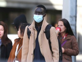 A pedestrian walks near City Hall in downtown Calgary on Friday, November 5, 2021.