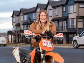 Janyce Archutick with her motorbike in front of Belmont Park townhomes by Streetside Develoments.