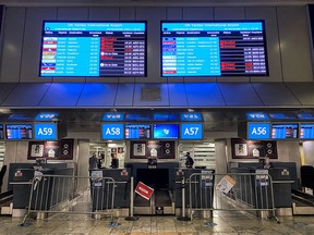 Digital display boards show cancelled flights to London-Heathrow at O.R. Tambo International Airport in Johannesburg, South Africa, on Friday, Nov. 26, 2021.