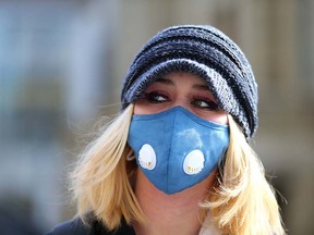 A pedestrian walks near city hall in downtown Calgary on Friday, Nov. 5, 2021.