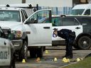 An ASIRT investigator looks at the scene of a 2019 Edmonton police-involved shooting near 100 Street and 105A Avenue.  The head of the agency says ASIRT is struggling under an ever-increasing file count, along with funding and staffing issues.