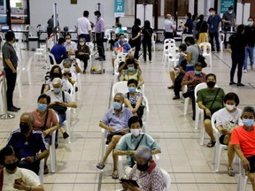 People above 70 years old wait in an observation area after getting a dose of the coronavirus disease (COVID-19) vaccine at a vaccination center in Singapore January 27, 2021.