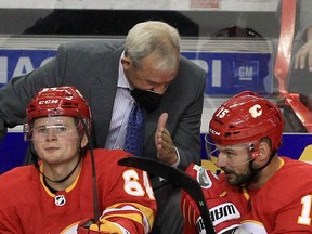 Flames head coach Darryl Sutter offers some instruction during a game earlier this season.