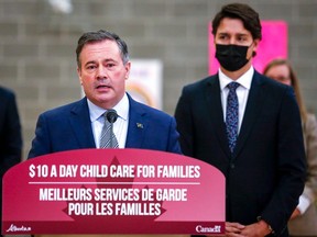 Prime Minister Justin Trudeau, right, looks on as as Alberta Premier Jason Kenney makes a child care announcement in Edmonton on Monday, Nov. 15, 2021.