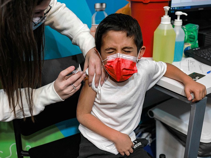  An Israeli health worker administers a dose of the Pfizer/BioNTech COVID-19 vaccine to a six-year-old child in Jerusalem on Tuesday, Nov. 23, 2021.