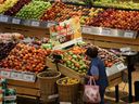 A woman browses the fruit section of a Loblaw supermarket in Collingwood, Ont.