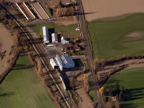 Rail cars on train tracks surrounded by flooded farmland in the Sumas Prairie near Abbotsford, British Columbia, Canada, on Friday, Nov. 19, 2021.