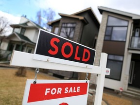 A file photo shows a for sale sign outside a home in Calgary.