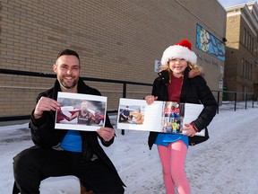 Grade 3 teacher Geoff Kearney holding a photo of Canadian Paralympian Nate Riech, and student Josephine Brown holding a page from the book Porchraits with a portrait of her Paralympian aunt and uncle pose for a photo outside Colonel Walker School on Monday, December 13, 2021.
