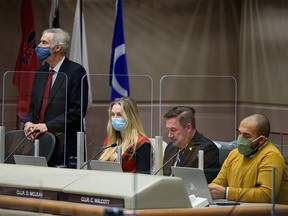 Councillors Richard Pootmans, left, Jennifer Wyness, Dan McLean, and Courtney Walcott during the last Calgary Council meeting before the Christmas break on Monday, December 20, 2021.